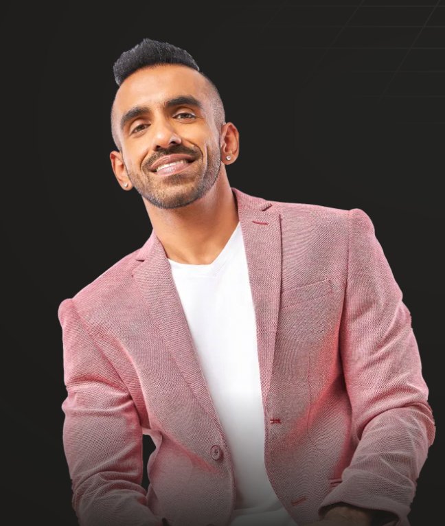 Avi smiling in a blazer